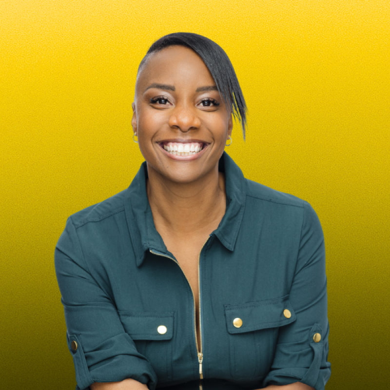 Woman wearing a teal jacket against a yellow background